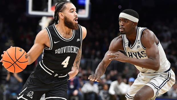 Providence Friars guard Jared Bynum (4) looks to pass as Georgetown Hoyas guard Denver Anglin (4) defends during the second half at Capital One Arena.